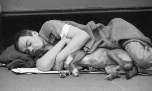 homeless man hugging his dog